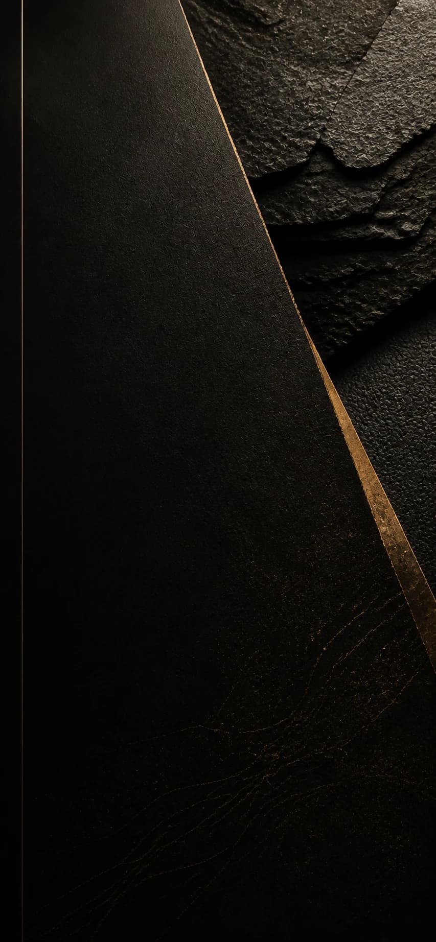 Layered black paper, leather and mineral textures with a bronze seam